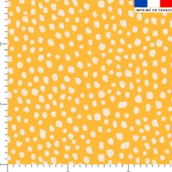 Tissu imperméable motif tacheté blanc fond jaune