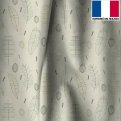 Tissu occultant grège motif silhouettes de feuilles vertes